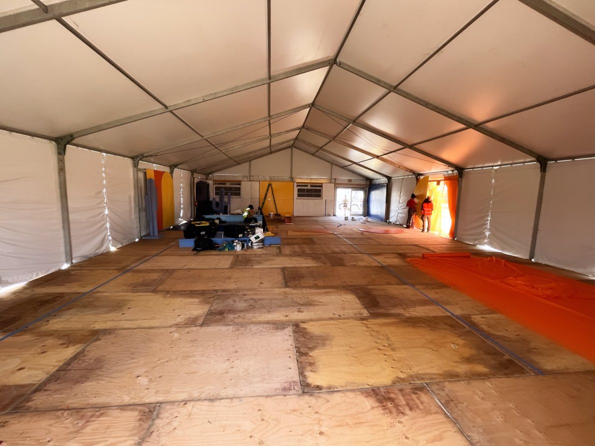 Festival tent during the build, bare plywood floor